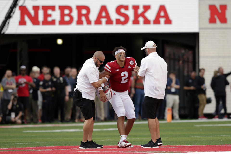 Nebraska trainers help injured quarterback Adrian Martinez off the field during the second half against Colorado. Colorado won 33-28. (AP Photo/Nati Harnik)