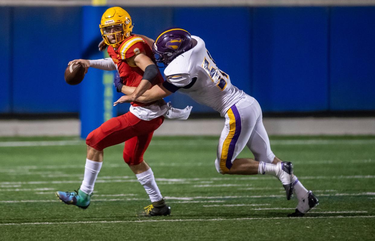 Palma High School quarterback Luke Rossi (2) is tackled by Salinas High School's Aidan Flynn (51) inside the Rabobank Stadium in Salinas, Calif., on Friday, Nov. 5, 2021.