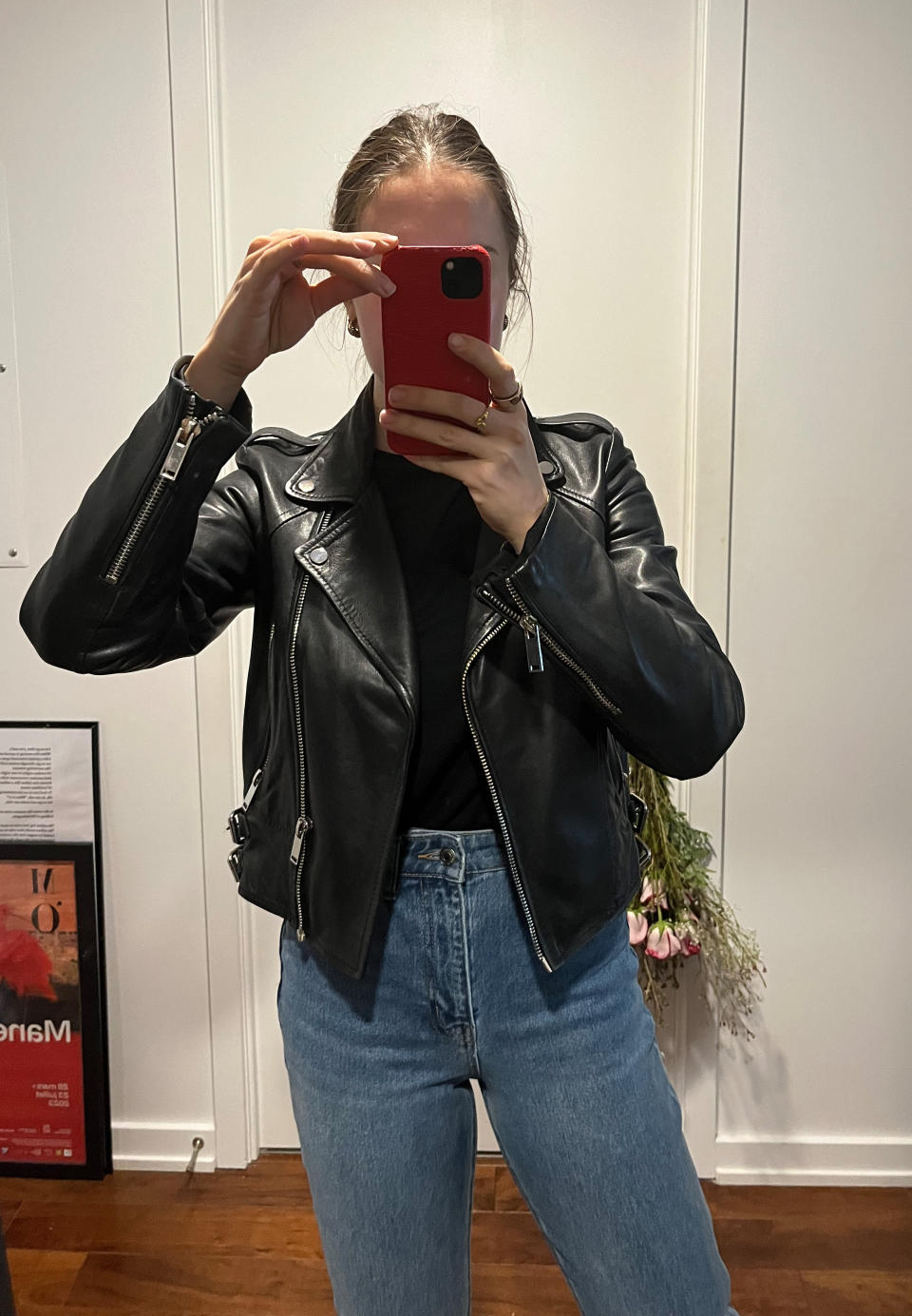 woman taking mirror selfie wearing black leather jacket, black t-shirt and blue H&M's Slim Straight High Ankle Jeans (Photo via author)