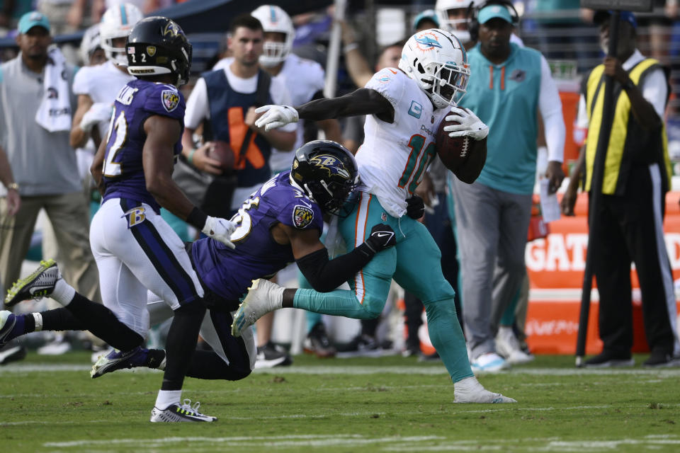 Baltimore Ravens safety Chuck Clark (36) tackles Miami Dolphins wide receiver Tyreek Hill (10) during the second half of an NFL football game, Sunday, Sept. 18, 2022, in Baltimore. (AP Photo/Nick Wass)