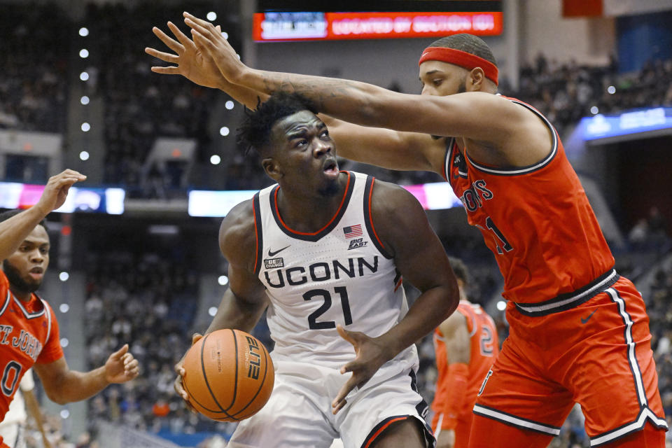 UConn's Adama Sanogo (21) looks to shoot as St. John's Joel Soriano defends in the first half of an NCAA college basketball game, Sunday, Jan. 15, 2023, in Hartford, Conn. (AP Photo/Jessica Hill)