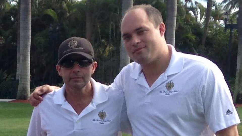 Carlos De Oliveira, left, and Brian Butler, right, pose for a photo in 2014 at Mar-a-Lago in Palm Beach, Florida. - Obtained by CNN