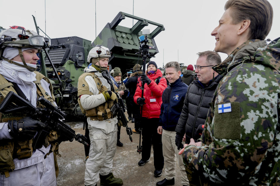 Sweden's Defense Minister Pål Jonson, centre right, Norway's Defense Minister Bjørn Arild Gram, second right and Finland's Defense Minister Antti Häkkänen react as Norwegian, Swedish and Finnish forces meet on the border between the three countries , during a NATO training exercise, in Kautokeino, Norway, Saturday, March 9, 2024, Large NATO drills in the frigid fjords of northern Norway may be just war games meant to hone the skills of the newly expanded 32-nation military alliance in the event of conflict. But for the troops taking part, they are very real. (Heiko Junge /NTB Scanpix via AP)