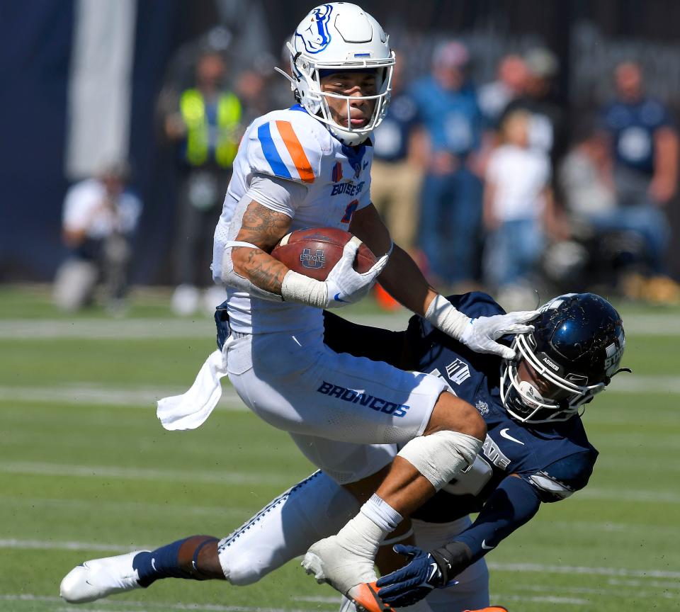 Boise State wide receiver Khalil Shakir (2) spins away from Utah State safety Dusten Ramseyer-Burdett (36) during the second half of an NCAA college football game Saturday, Sept. 25, 2021, in Logan, Utah. (Eli Lucero/The Herald Journal via AP)