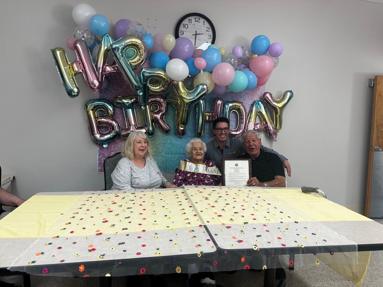 Meta Kopruch, with daughter, Heidi Jones, son, Klaus Kopruch, and Kings Mountain Mayor Rob Wagman, during her 105th birthday celebration at White Oak Manor in Kings Mountain Monday.