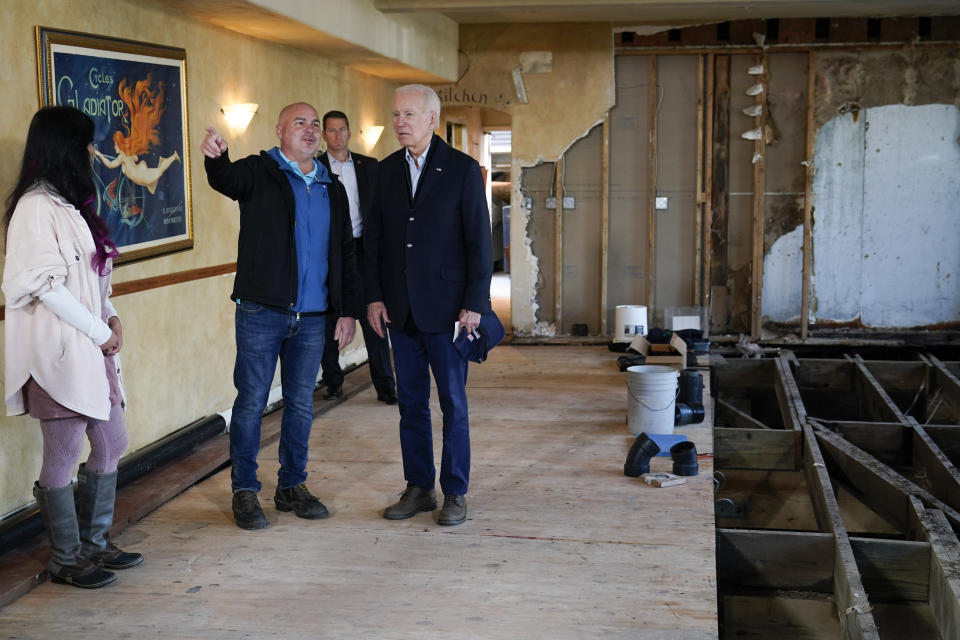 President Joe Biden talks with Paradise Beach Grille co-owners Chuck Maier and Ally Gotlieb, left, as he visitswith business owners and local residentsin Capitola,Calif., Thursday, Jan 19, 2023,to survey recovery efforts following a series of severe storms. (AP Photo/Susan Walsh)