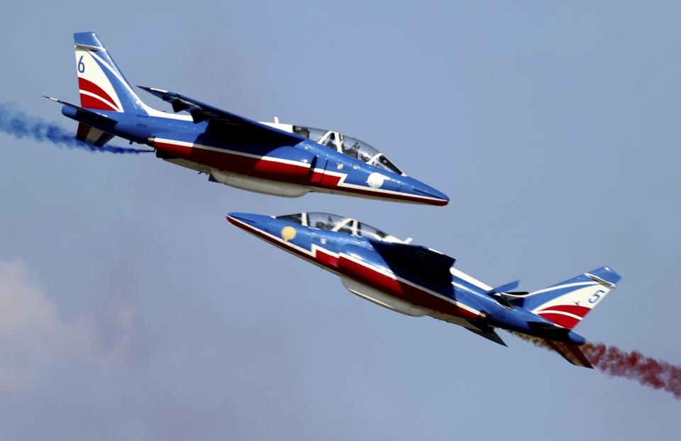 French aircrafts of the Patrouille de France spray colored smoke during a performance on the opening day of the Dubai Airshow in Dubai, United Arab Emirates, Sunday, Nov. 17, 2019. (AP Photo/Kamran Jebreili)