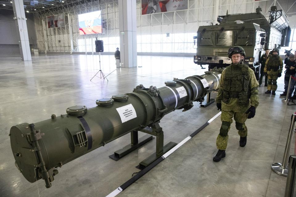 FILE - A Russian military officer walks past the 9M729 land-based cruise missile on display in Kubinka outside Moscow, Russia, on Jan. 23, 2019. Russian President Vladimir Putin has called for resuming production of intermediate-range missiles that were banned under a now-scrapped treaty with the US. The Intermediate-Range Nuclear Forces treaty, which banned ground-based missiles with a range of 500-5,500 kilometers (310-3,410 miles) was regarded as an arms control landmark when Soviet leader Mikhail Gorbachev and U.S. President Ronald Reagan signed it in 1988. (AP Photo/Pavel Golovkin, File)