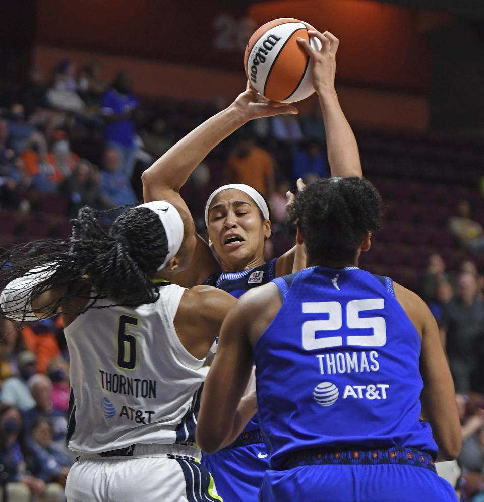 Dallas Wings forward Kayla Thornton (6) fouls Connecticut Sun center Brionna Jones (42) during the first half of a WNBA basketball game Tuesday, May 24, 2022 at Mohegan Sun Arena in Uncasville, Conn. (Sean D. Elliot/The Day via AP)