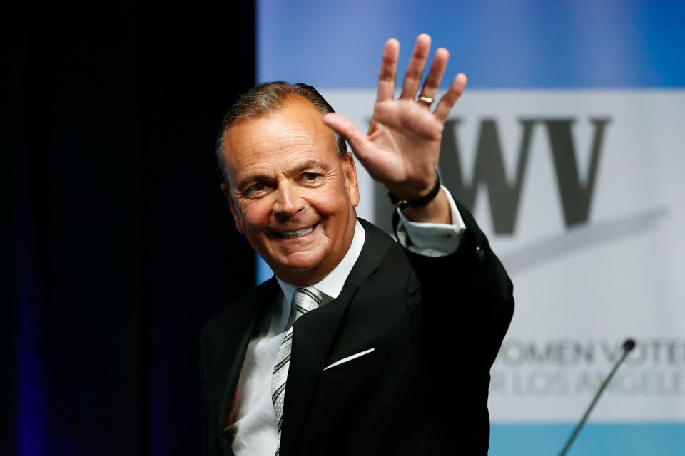 Businessman Rick Caruso waves at the start of a mayoral debate at the Student Union Theater on the California State University, Los Angeles campus on May 1.