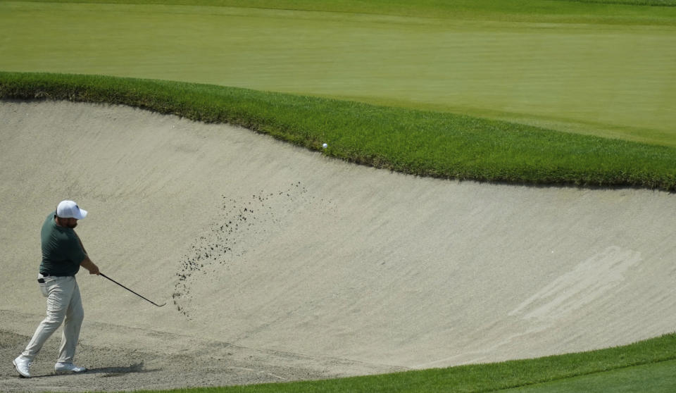Shane Lowry of Ireland plays a shot from a bunker on the 9th hole during the third round of the men's golf event at the 2020 Summer Olympics on Saturday, July 31, 2021, in Kawagoe, Japan. (AP Photo/Matt York)