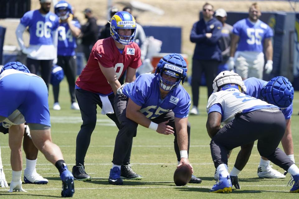 Rams quarterback Matthew Stafford takes a snap from center Coleman Shelton during camp.