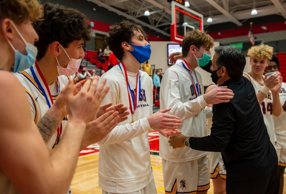 OLSH head coach Mike Rodriguez congratulates his players after giving them their WPIAL Class 2A championship medals last season at Peters Township High School.