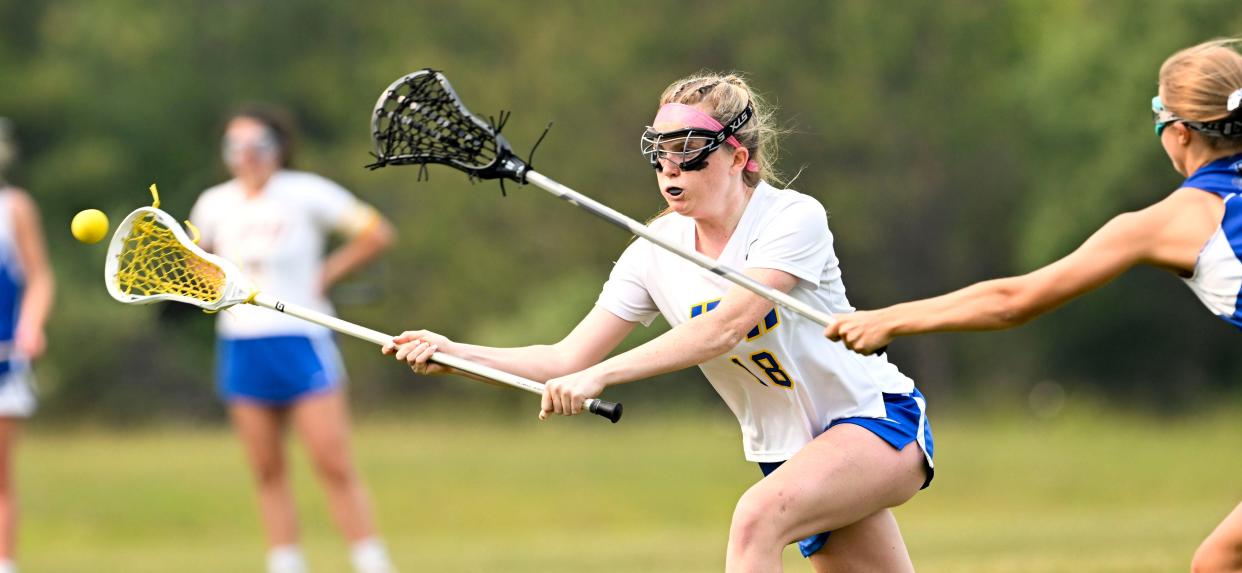 Mia Curley of St. John Paul II puts a shot on Lunenburg goal with Sierra Bursch reaching in.