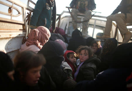 Displaced Iraqis, fleeing villages under Islamic State control, sit in a van as security forces backed by tribal militias battle to retake area on the eastern bank of the river Tigris, Iraq December 7, 2016. REUTERS/Mohammed Salem