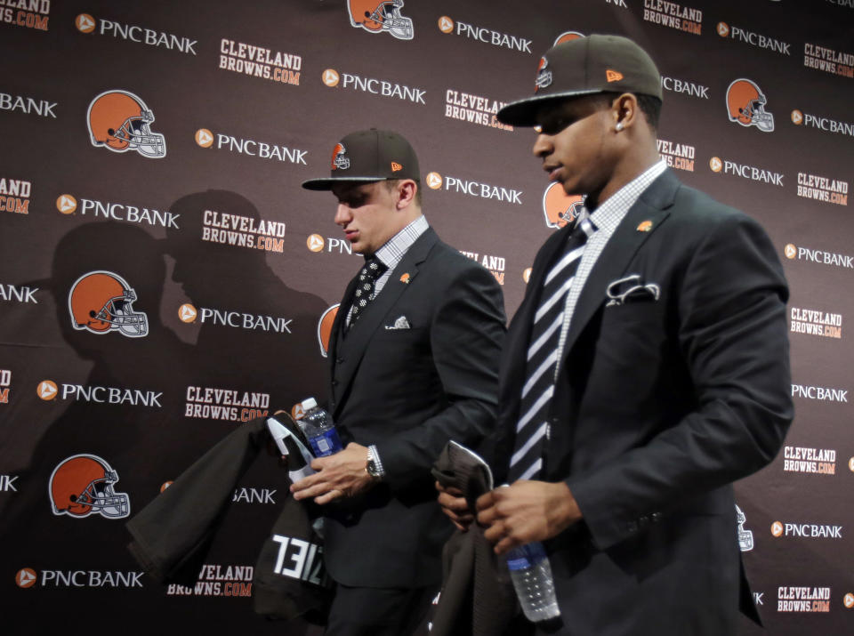 Cleveland Browns quarterback Johnny Manziel, left, and cornerback Justin Gilbert, leave their introductory news conference at the NFL football team's facility in Berea, Ohio Friday, May 9, 2014. Cleveland Browns quarterback Johnny Manziel, from Texas A&M, answers questions at his introductory news conference at the NFL football team's facility in Berea, Ohio Friday, May 9, 2014. The Browns selected Manziel 22nd overall in the first round in Thursday's NFL draft, after taking Oklahoma State cornerback Justin Gilbert with the eighth pick. (AP Photo/Tony Dejak)