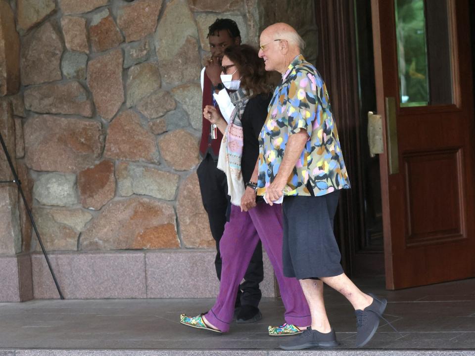 IAC chairman Barry Diller and fashion designer Diane von Furstenberg walk outside lodge at Sun Valley conference