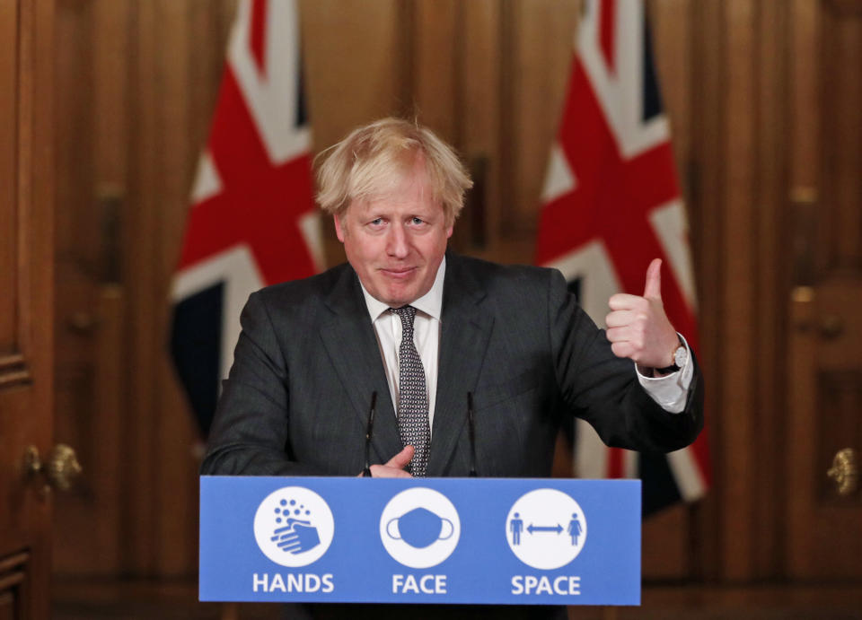 Britain's Prime Minister Boris Johnson speaks at a press conference in 10 Downing Street, London, Wednesday Dec. 30, 2020. The British government on Wednesday extended its toughest coronavirus restrictions to more than three-quarters of England’s population, saying a fast-spreading new variant of the virus has reached most of the country. (Heathcliff O'Malley/Pool via AP)