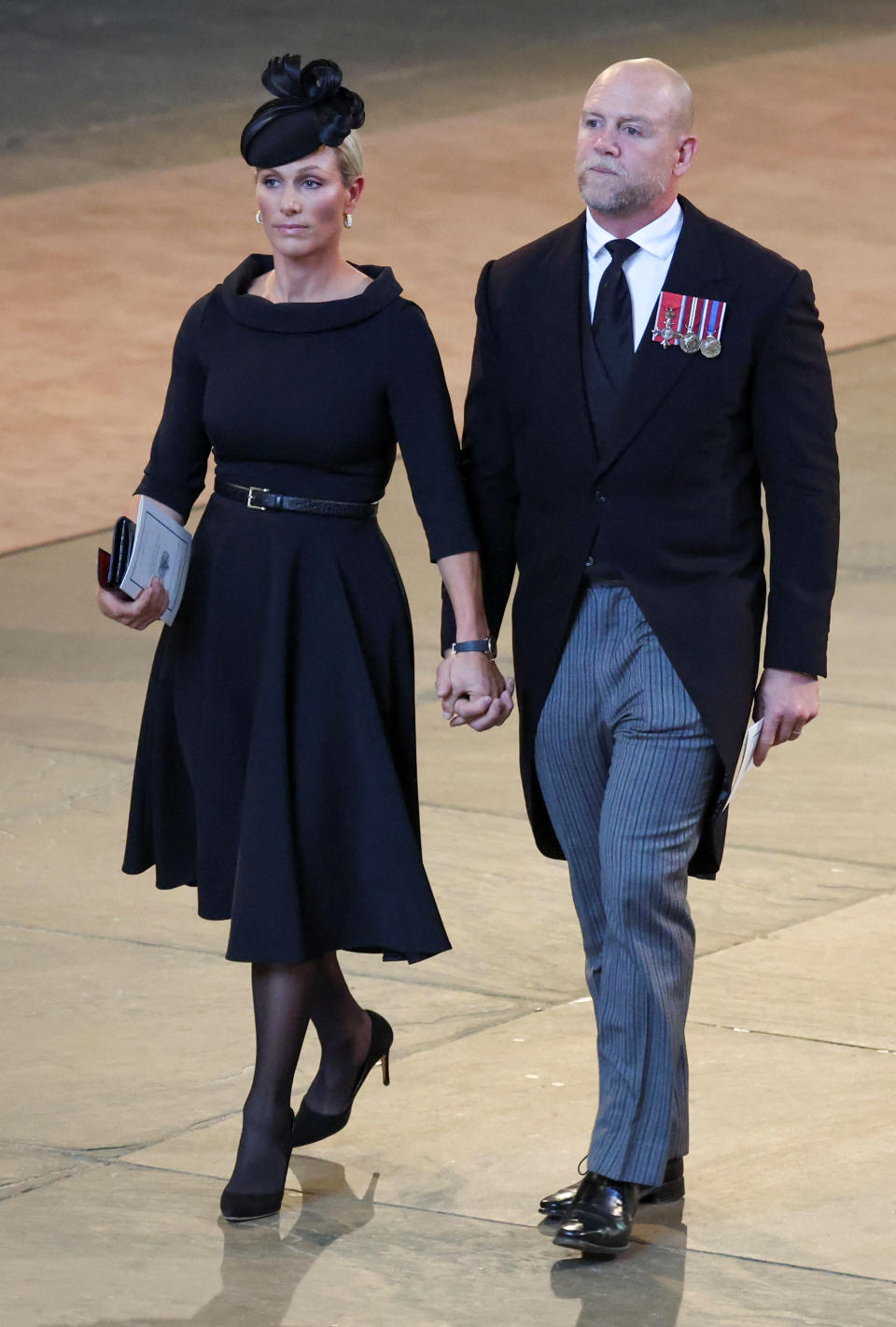 As non-working royals, Zara Tindall and her husband Mike Tindall are often seen holding hands, pictured during a procession with the Queen's coffin last week. (Getty Images)