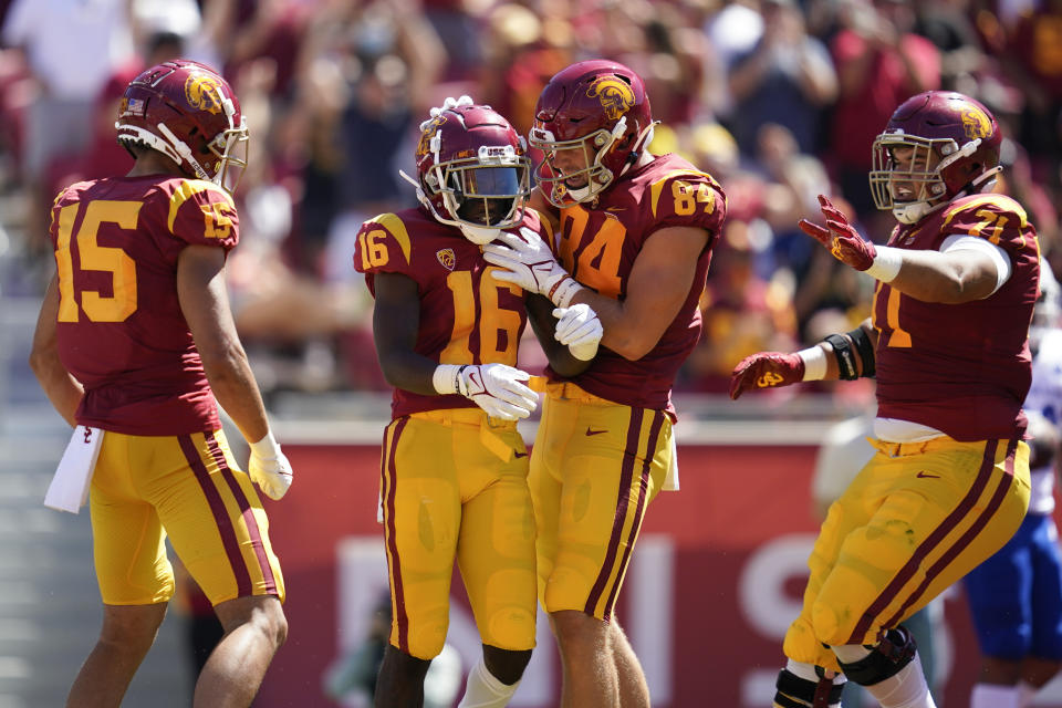 Southern California wide receiver Tahj Washington (16) celebrates with tight end Erik Krommenhoek (84) after catching a pass in the end zone for a touchdown during the first half of an NCAA college football game against San Jose State Saturday, Sept. 4, 2021, in Los Angeles. (AP Photo/Ashley Landis)
