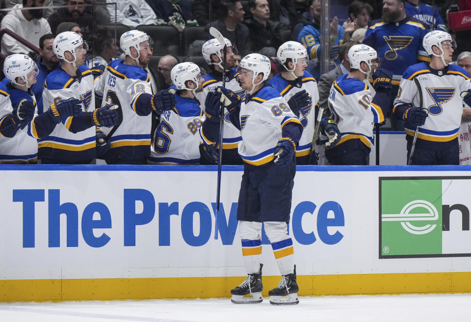 St. Louis Blues' Pavel Buchnevich (89) is congratulated for his goal against the Vancouver Canucks during the first period of an NHL hockey game Wednesday, Jan. 24, 2024, in Vancouver, British Columbia. (Darryl Dyck/The Canadian Press via AP)