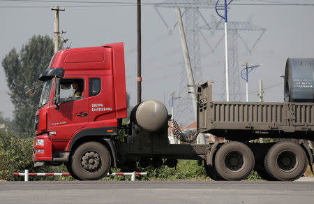 A liquefied natural gas (LNG) truck drives along a road in Yutian county, China's Hebei province September 29, 2017. Picture taken September 29, 2017. REUTERS/Jason Lee