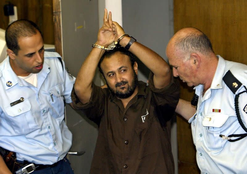 FILE PHOTO: Marwan Barghouti, a popular Palestinian leader, gestures as Israeli police bring him into the District Court for his judgment hearing in Tel Aviv