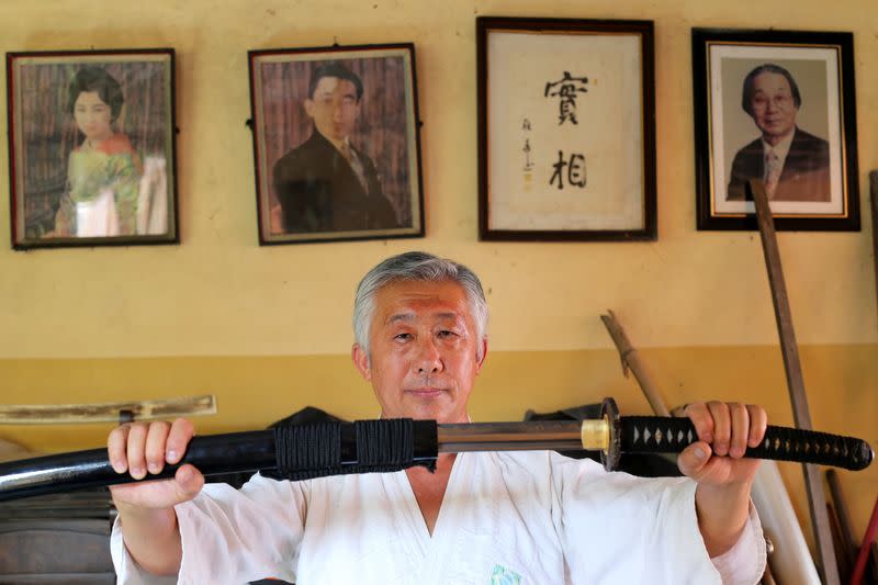 Samurai Suemitsu shows a katana sword at his home in Curitiba