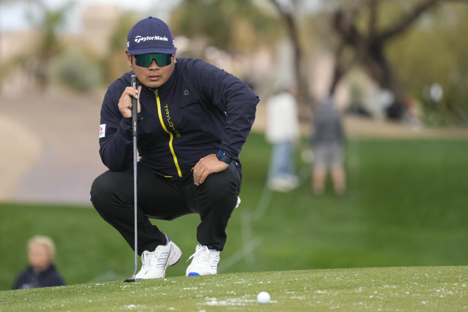 Ryo Hisatsune, of Japan, lines up a putt at the second hole during the continuation of the second round of the Phoenix Open golf tournament Saturday, Feb. 10, 2024, in Scottsdale, Ariz. (AP Photo/Ross D. Franklin)