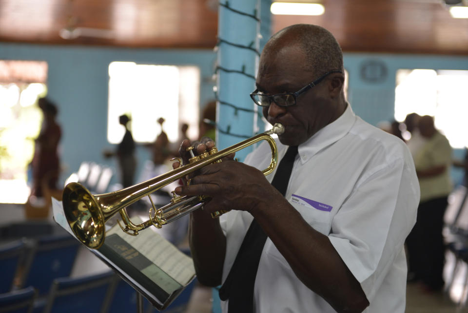 In this Sunday, Feb. 16, 2014, photo, music instructor Winston “Sparrow” Martin is shown playing a trumpet, leading a band of former students at a church service in Kingston, Jamaica. The veteran bandmaster has provided a solid musical foundation for numerous boys at Alpha Boys’ School, a residential vocational school in Kingston which has been a cornerstone of Jamaica’s prolific musical culture for over a century. (AP Photo/David McFadden)