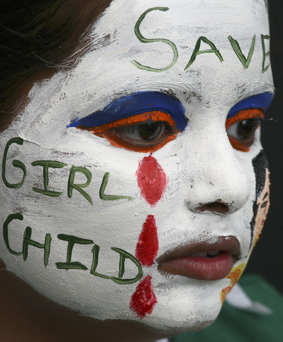 A girl with her face painted with an awareness message on female foeticide participates in a face-painting competition in the northern Indian city of Chandigarh August 1, 2009. REUTERS/Ajay Verma (INDIA SOCIETY IMAGES OF THE DAY) - GM1E582071X01