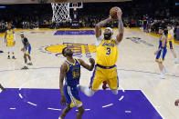 Los Angeles Lakers forward Anthony Davis (3) shoots as Golden State Warriors forward Andrew Wiggins defends during the first half in Game 4 of an NBA basketball Western Conference semifinal Monday, May 8, 2023, in Los Angeles. (AP Photo/Marcio Jose Sanchez)