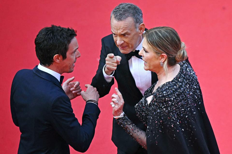 US actor Tom Hanks (C) and US actress Rita Wilson speak with a staff member as they arrive for the screening of the film "Asteroid City" during the 76th edition of the Cannes Film Festival in Cannes, southern France, on May 23, 2023. (Photo by Antonin THUILLIER / AFP) (Photo by ANTONIN THUILLIER/AFP via Getty Images)