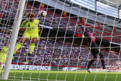 VANCOUVER, BC - JUNE 12: Yuika Sugasawa #15 of Japan heads the ball past Annette Ngo Ndom #1 of Cameroon for Japan&#39;s second goal during the FIFA Women&#39;s World Cup Canada 2015 Group C match between Japan and Cameroon June 12, 2015 at BC Place Stadium in Vancouver, British Columbia, Canada. (Photo by Jeff Vinnick/Getty Images)