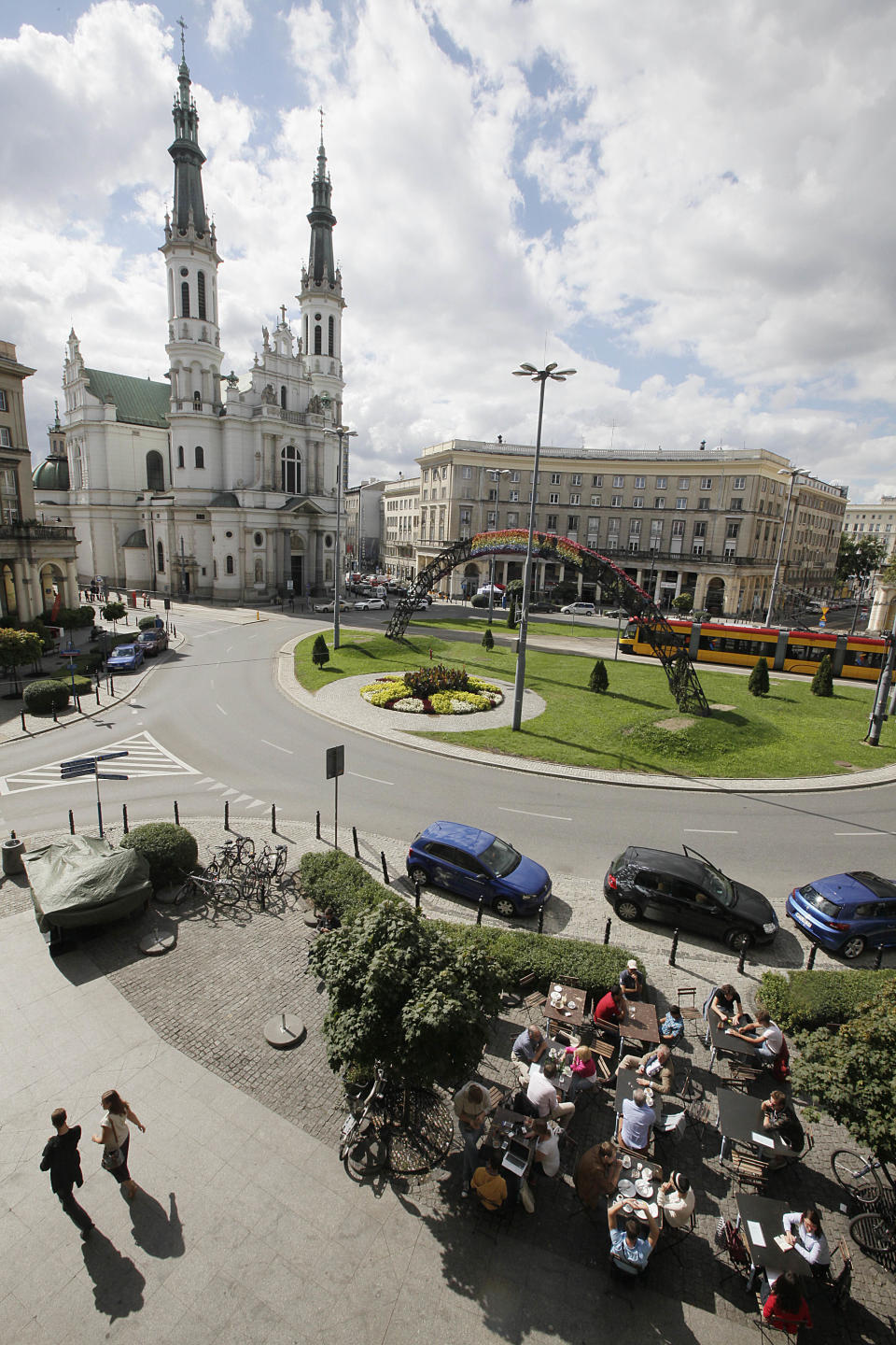 In this picture taken Sept. 5, 2013, people gather in Savior Square in Warsaw, Poland. Dating back to the 19th century and severely damaged by the German Nazis during World War II, it has become one of the capital city’s trendiest places after political and economic reform and attracts tourists, students and professionals with its numerous cafes and leisurely ambiance. (AP Photo/Czarek Sokolowski)