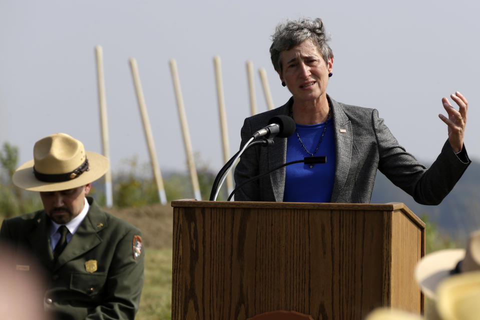 Secretary of the Interior Sally Jewell, right, makes remarks before leading the ground breaking for the Flight 93 National Memorial visitor center complex on Tuesday, Sept.10, 2013 in Shanksville, Pa. The 6,800 foot visitor center is designed so that the building will be broken in two at the point of the plane’s flight path, and is expected to open in late 2015. The ridge will be built up to give people a clear view of the crash site, which is near a memorial wall that lists the names of all 33 passengers and seven crew members who were killed. Flight 93 was traveling from Newark, N.J., to San Francisco on Sept. 11, 2001, when it was diverted from the likely goal of crashing it into the White House or Capitol. (AP Photo/Gene J. Puskar)