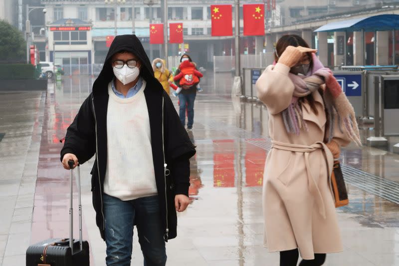 Passengers wearing masks are seen at the Changsha Railway Station, in Hunan