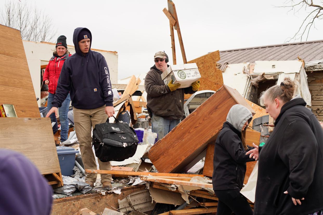 INDIAN LAKE, OHIO - MARCH 15: Families and neighbors help each other clean up after a tornado struck the area on March 15th, 2024 in Indian Lake, Ohio. The storms caused casualties, resulting in deaths, and left many people without homes.