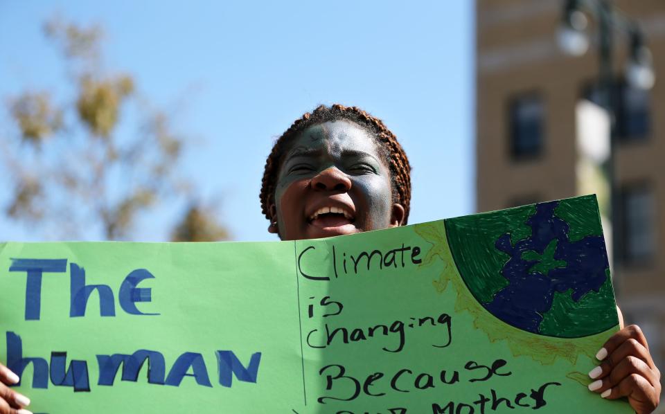 Ruscirene Dinanga, a junior from Portland High School, chants with a crowd of more than 2,000 outside of Portland City Hall on Friday to demand more aggressive action to combat climate change.