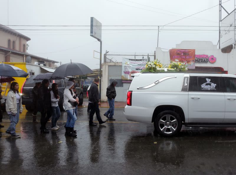 People attend the funeral of several of the victims killed by shooters at a slot-machine arcade in the central Mexican state of Michoacan, in Uruapan