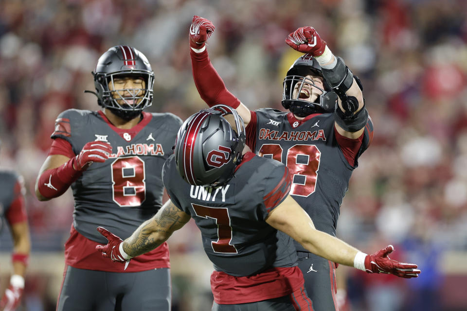 Oklahoma linebacker Danny Stutsman (28) and Oklahoma linebacker Jaren Kanak (7) celebrate after a tackle against West Virginia during the second half of an NCAA college football game Saturday, Nov. 11, 2023, in Norman, Okla. (AP Photo/Alonzo Adams)