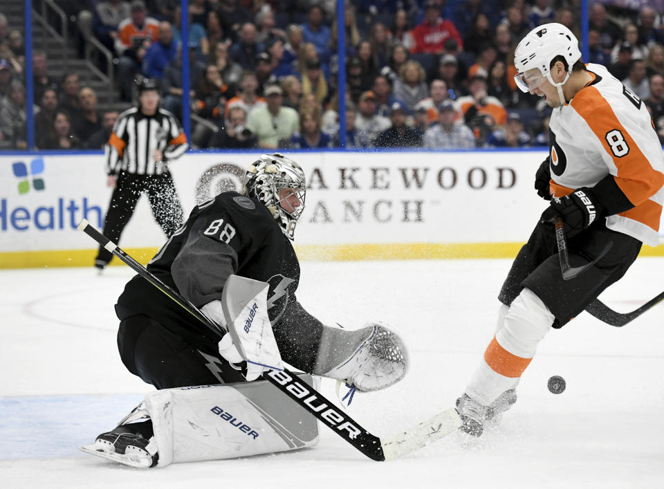 Tampa Bay Lightning goaltender Andrei Vasilevskiy (88) makes a save as Philadelphia Flyers defenseman Robert Hagg (8) looks for a rebound during the third period of an NHL hockey game Saturday, Feb. 15, 2020, in Tampa, Fla. (AP Photo/Jason Behnken)