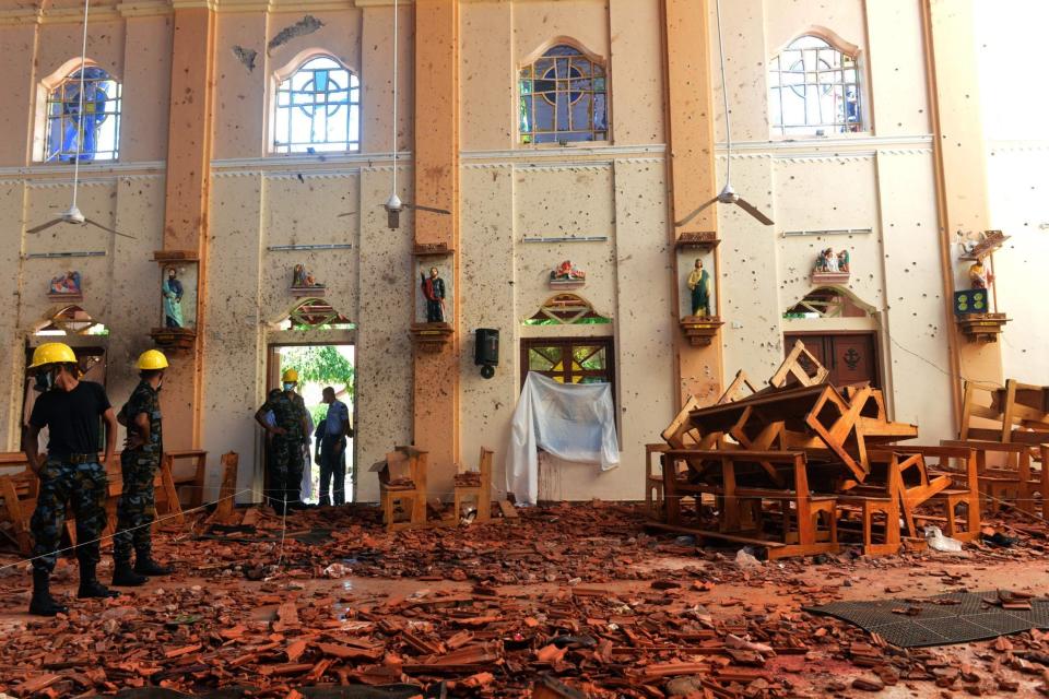 Security personnel inspect the interior of St. Sebastian's Church in Negombo (AFP/Getty Images)