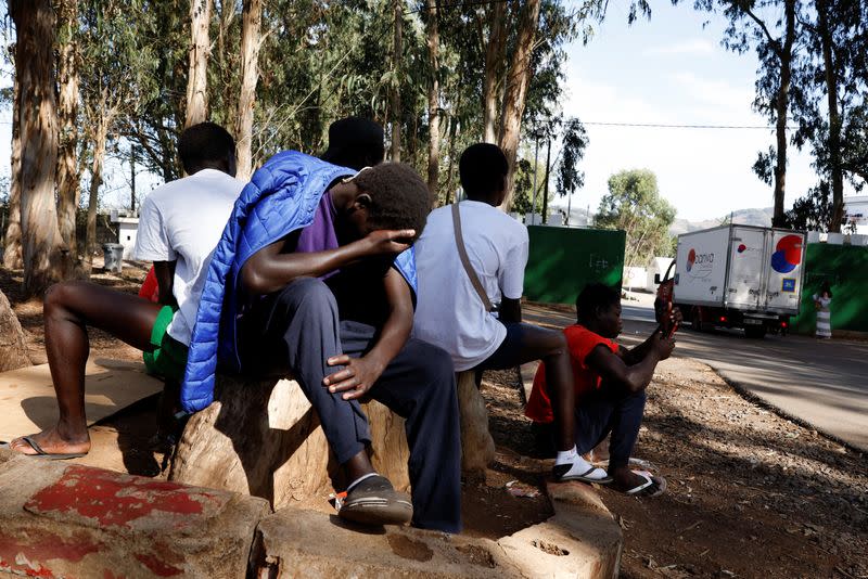 Migrants from Senegal sit outside of Las Raices migrant camp on the island of Tenerife