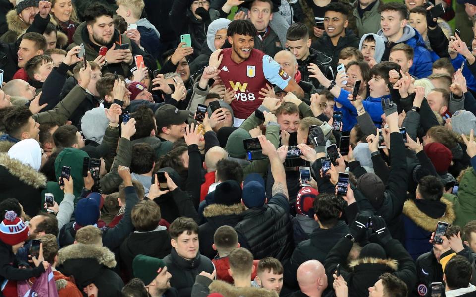  Fans swarm around Tyrone Mings of Villa as they celebrate victory after the Carabao Cup Semi Final match between Aston Villa and Leicester City at Villa Park - Getty Images