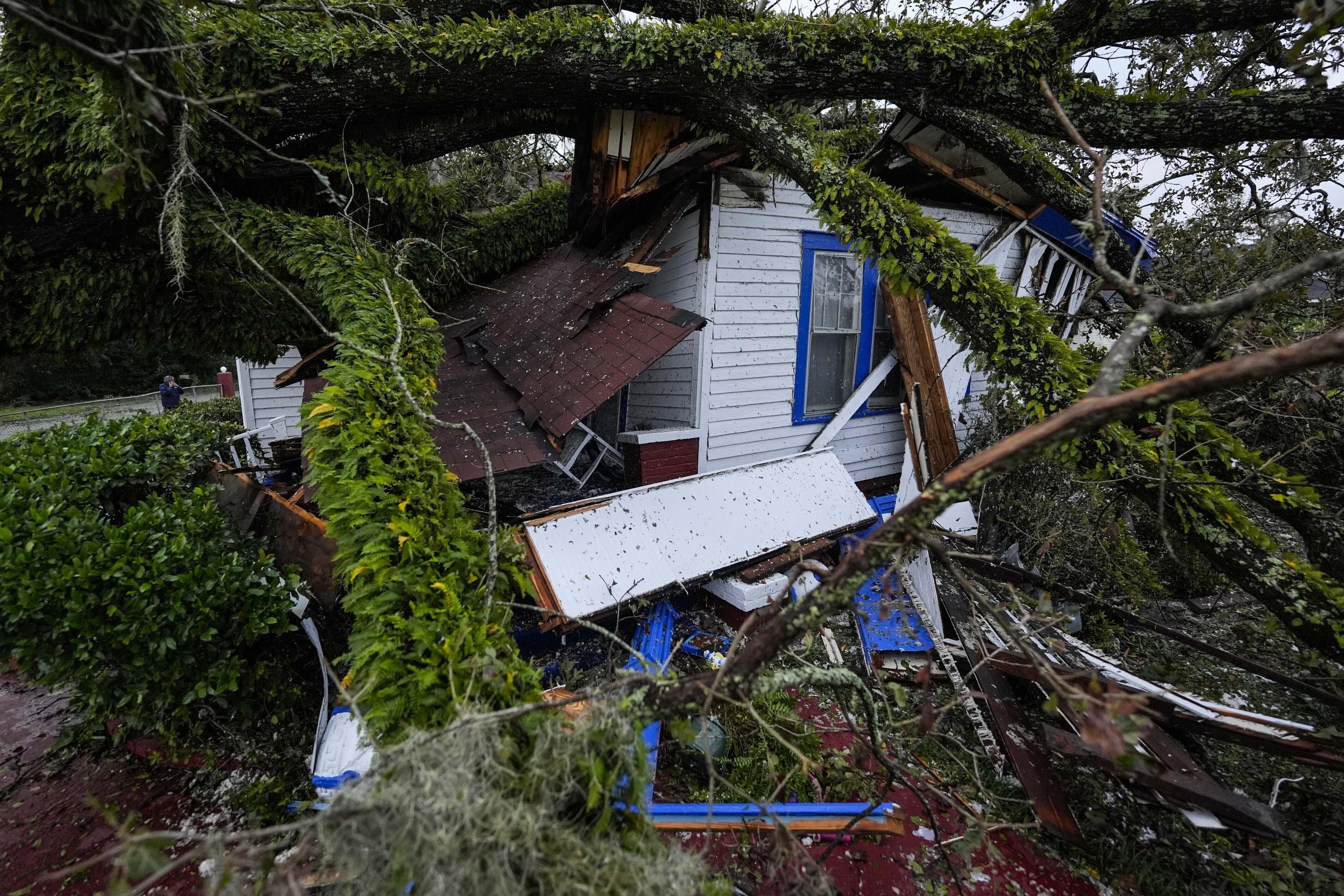 A damaged 100-year-old home is seen after an oak tree landed on it after Hurricane Helene moved through the area on Friday in Valdosta, Georgia. (Mike Stewart/AP)