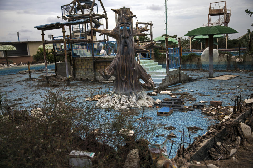 A theme-pool lays in ruins at an abandoned amusement park coined "Diversions Grano de Oro" in Maracaibo, Venezuela, May 23, 2019. Many structures in Maracaibo are littered with debris and reminiscent of wartime or the aftermath of a natural disaster. (AP Photo/Rodrigo Abd)