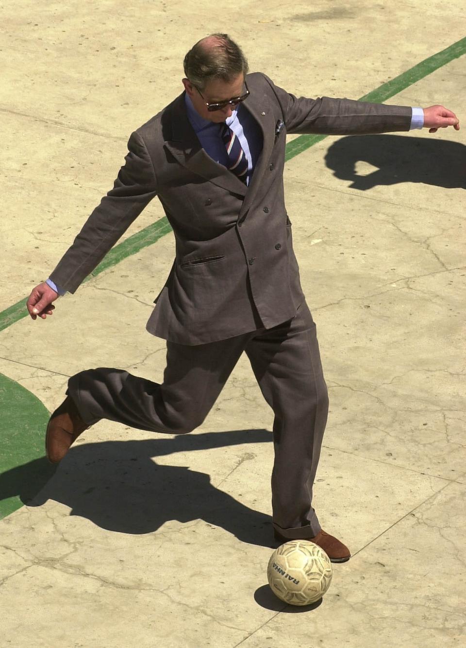 Britain's Prince Charles kicks a soccer ball at a cultural center in Rio de Janeiro, Brazil, Tuesday, March 5, 2002. Charles is on a two-day visit to the South American nation before heading to Mexico.