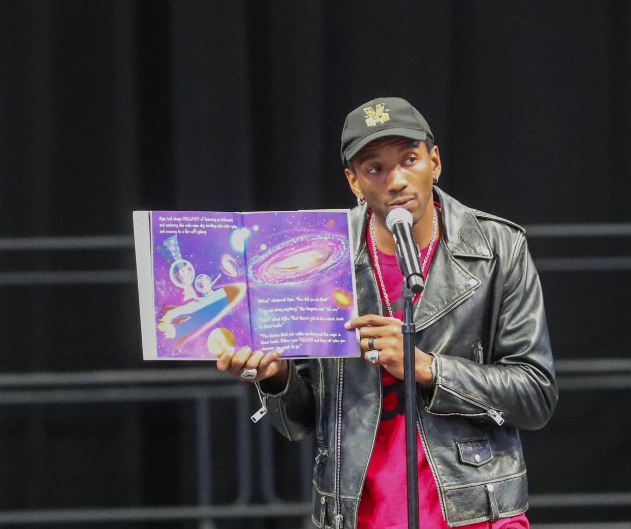 Former University of Georgia and New England Patriots wide receiver Malcolm Mitchell reads his book, "The Magician's Hat" on Tuesday, October 17, 2023 during a Reading Rally at Enmarket Arena.