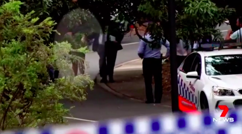 Police took the 16-year-old boy away with his hands bound in evidence bags. Source: 7News